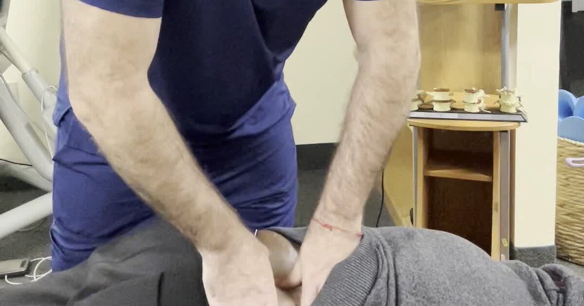 Dr. Derek Curran performing a low back adjustment on a patient at Maryland Chiropractic & Physical Medicine in Edgewater, MD